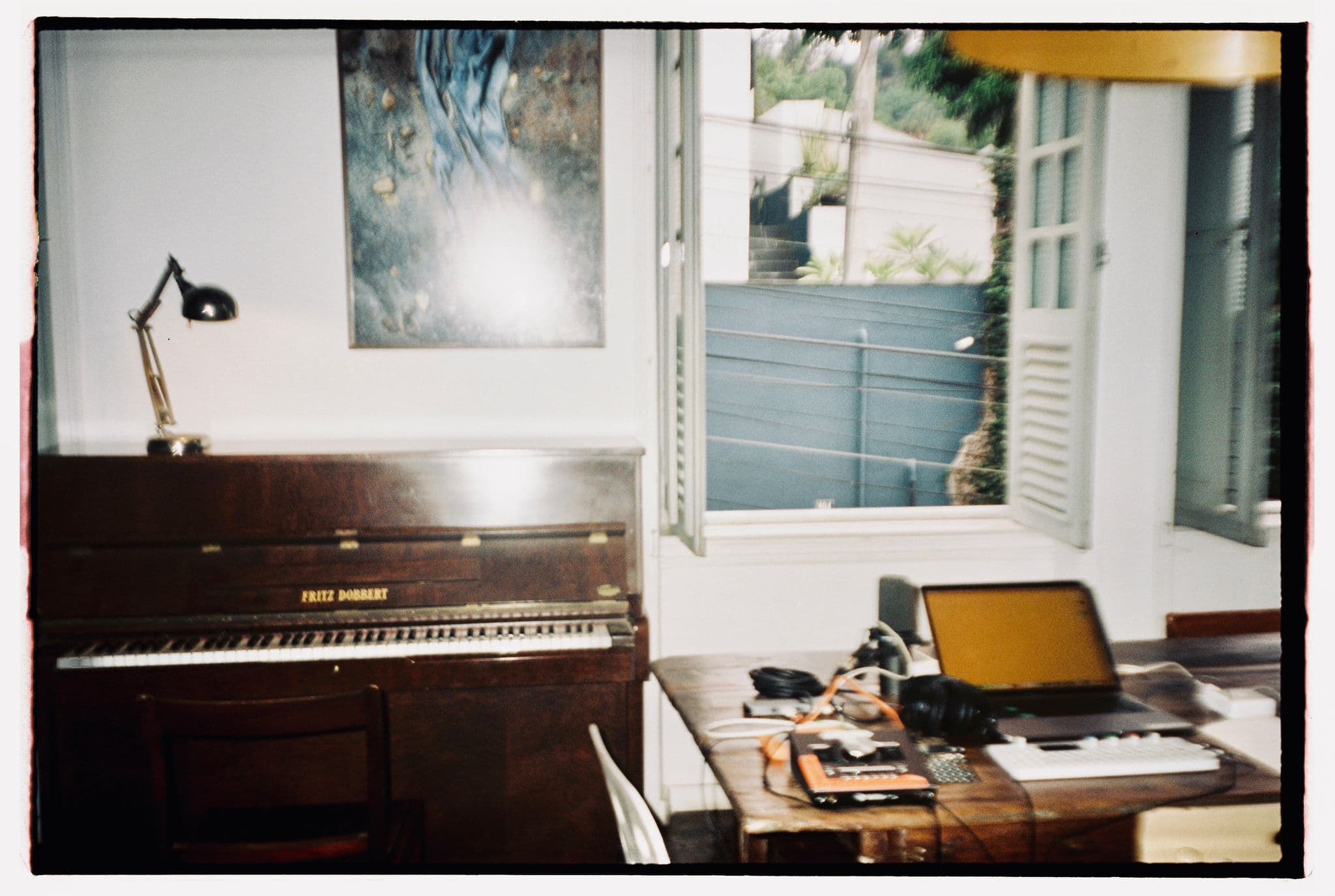 Piano and recording desk by an open window